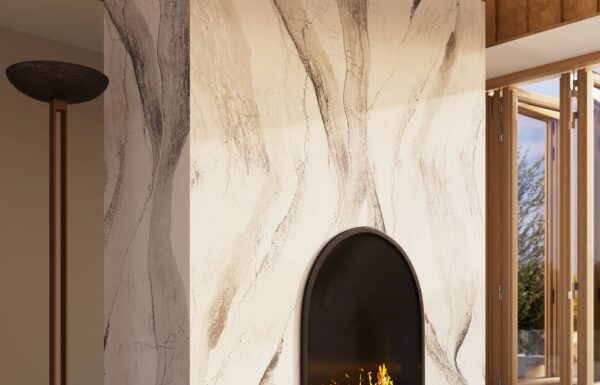 close up view of Windsor Brass Satin Ridge by Cambria Quartz countertops, showcasing its rich tapestry of chocolate brown and warm honey hues, debossed Inverness veins, and radiant brass elements. installed around a fireplace on walls